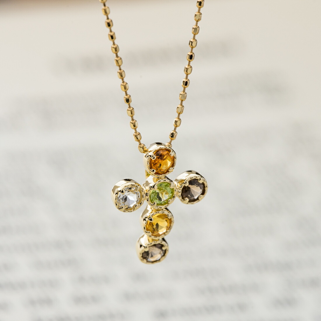 umu -アム- FINE JEWELRY STUIDIOアースカラー クロスモチーフ ペンダントトップ 「dolce」pn0286_kanban2.jpg